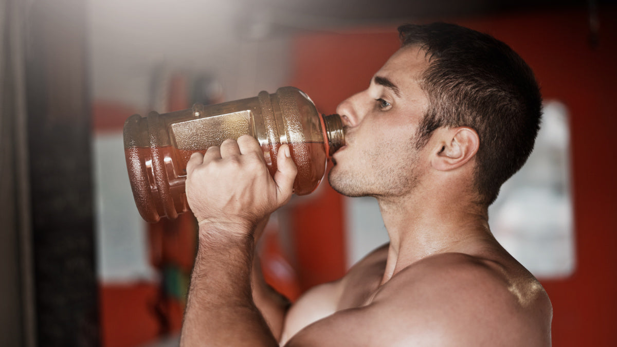 Man drinking water to get hydrated before fitness